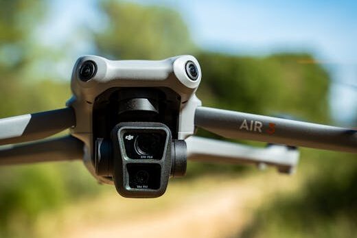 Drone flying low over a sunny nature trail, capturing serene landscape.